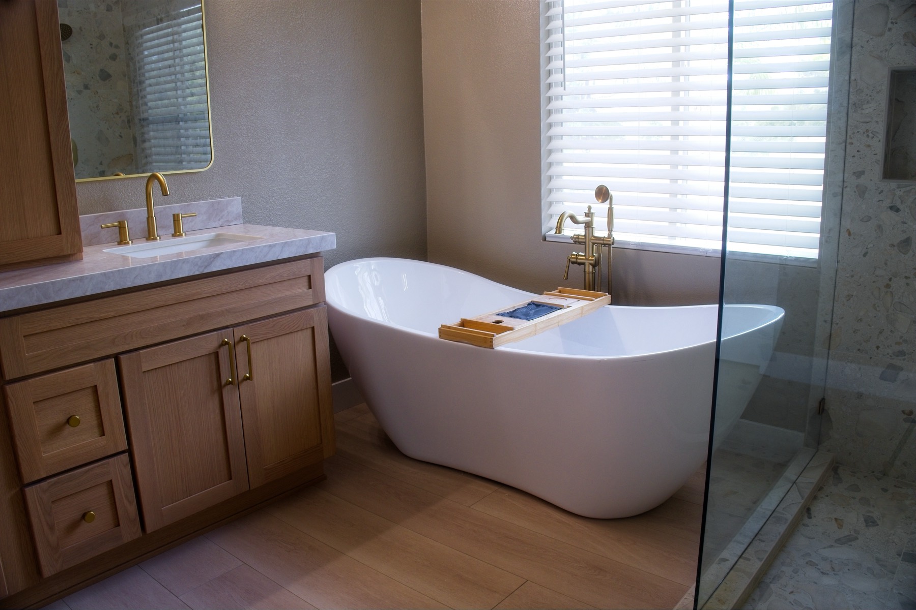 Bathroom after — subway-tile tub and glass shower